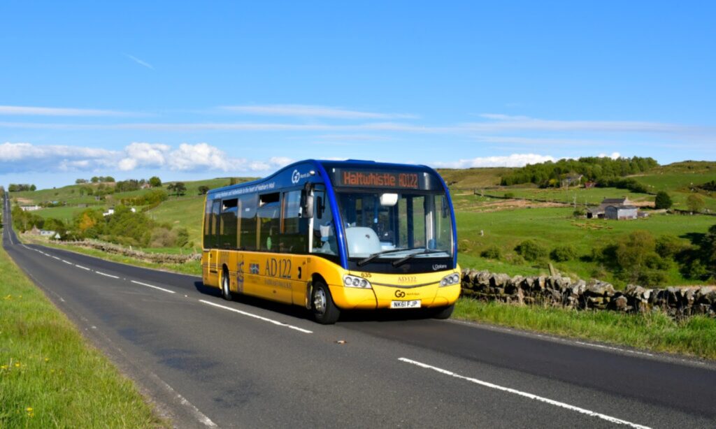 Hadrian's Wall Guide. Visiting Hadrian's Wall by public transport. Image of a bus speeding through open countryside.