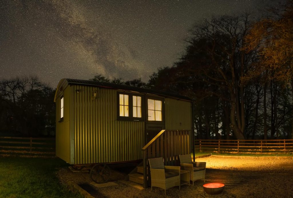 Wild wellness Hadrian's Wall blog - image of herdie hideaway shepherd's hut under a sky full of stars